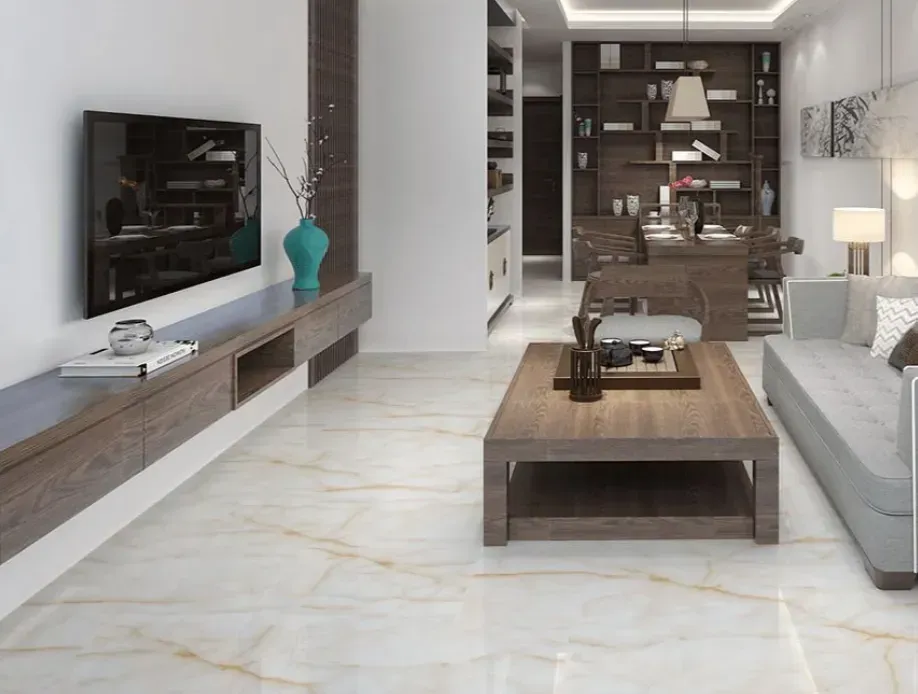 A modern living room with a gray sofa, a wood coffee table, and a wall-mounted TV over a long, dark wood media console.