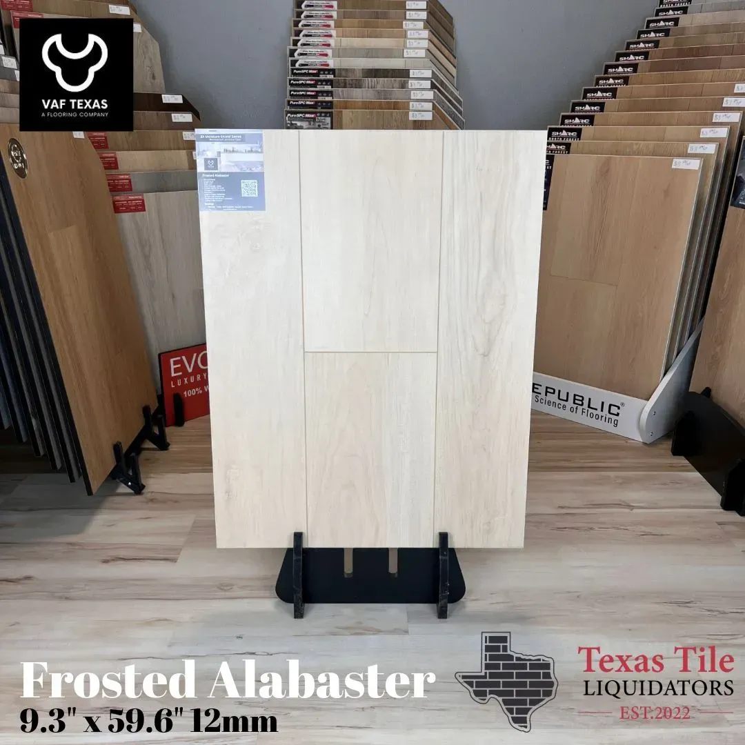 Sample of Frosted Alabaster light-toned laminate flooring displayed on a stand at Texas Tile Liquidators.