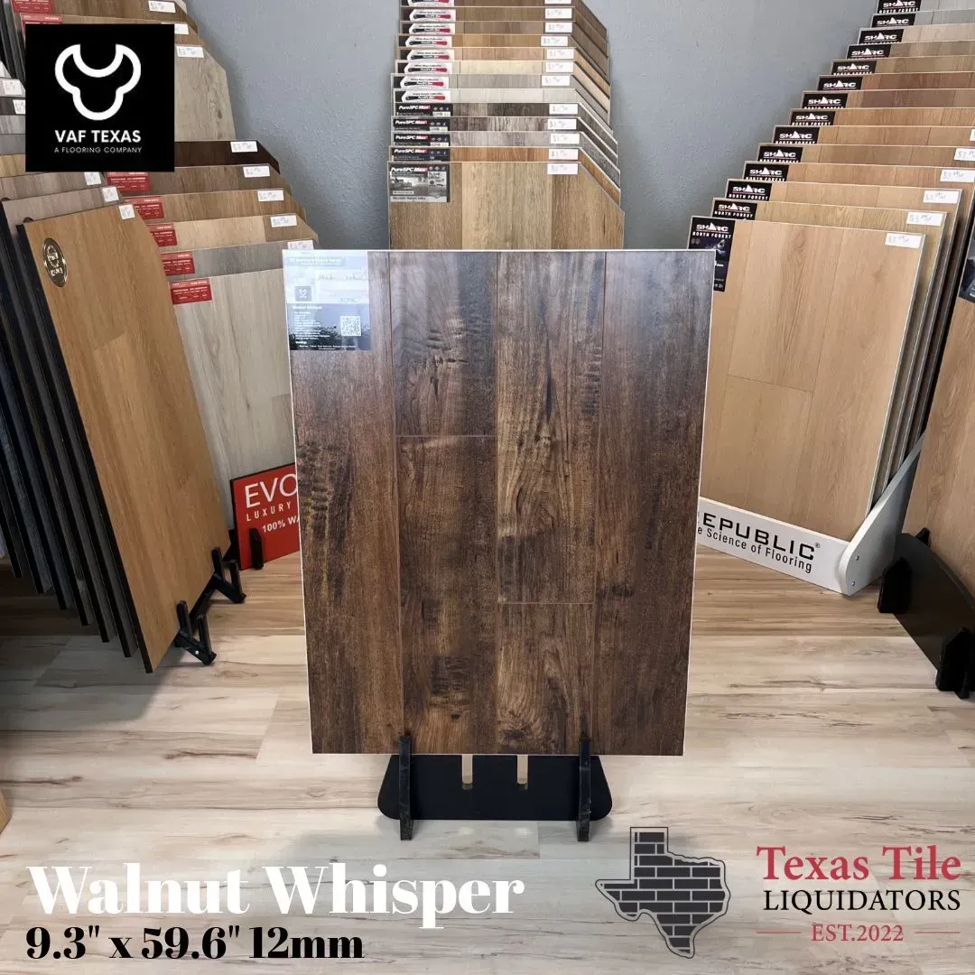 Wood-look tile display in a showroom, featuring a dark brown plank sample labeled “Walnut Whisper.”