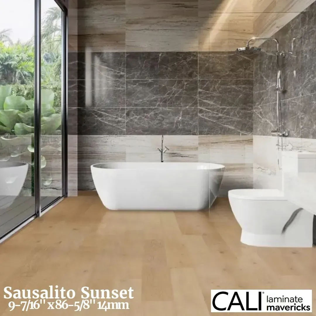 A modern bathroom featuring light wood-look flooring, a white freestanding tub, and dark marble tile walls.
