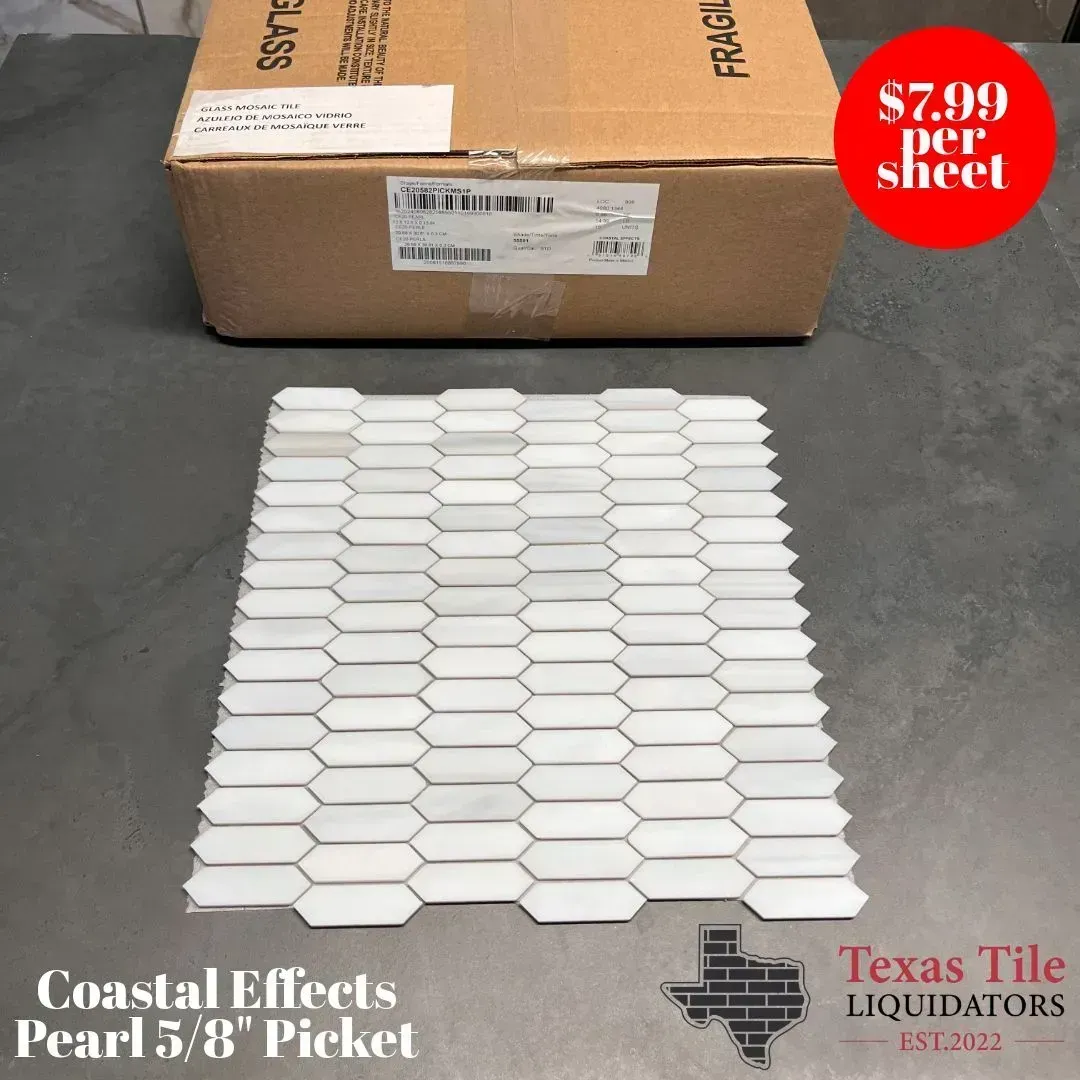 A sheet of light-colored, picket-style mosaic tiles in front of a cardboard box, with a price tag reading $7.99 per sheet.