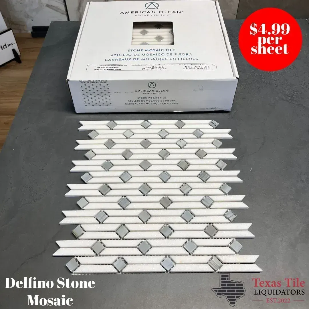 A sheet of white and grey stone mosaic tile sits in front of its product box, marked $4.99 per sheet at Texas Tile.