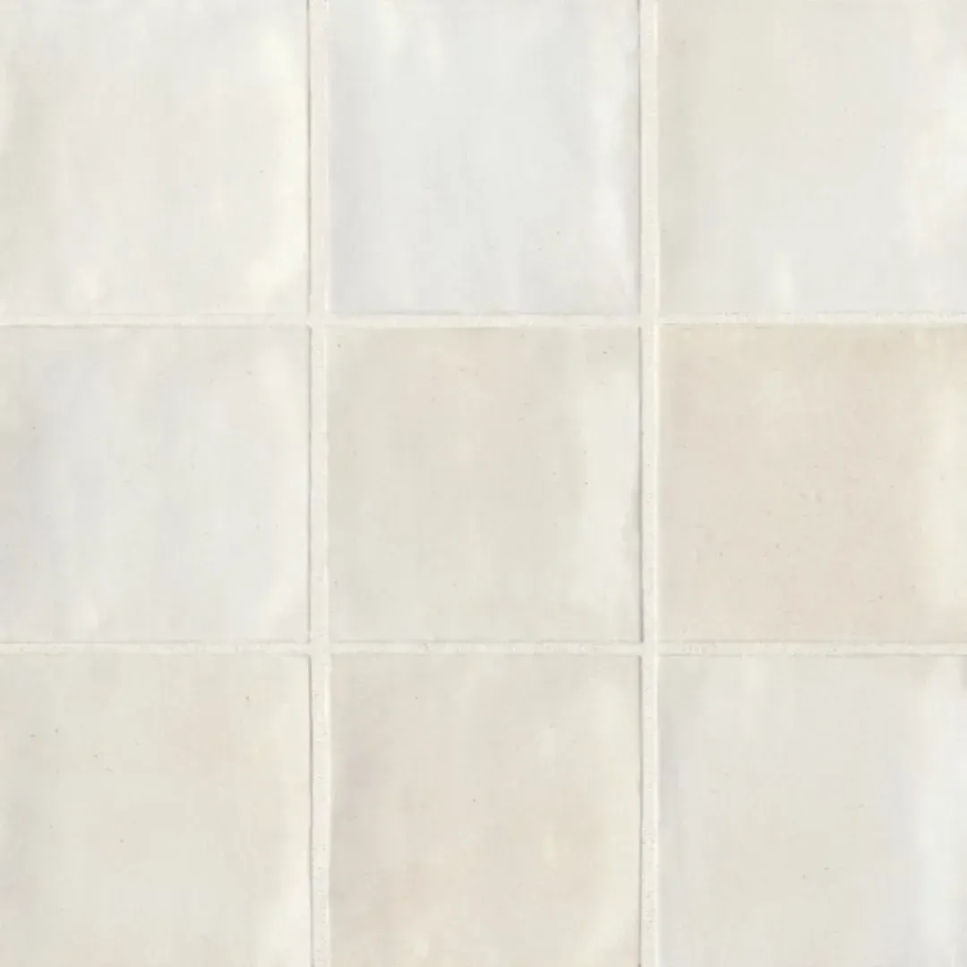 A grid of nine square, glossy, off-white ceramic tiles with subtle color variations and textured, wavy surfaces.