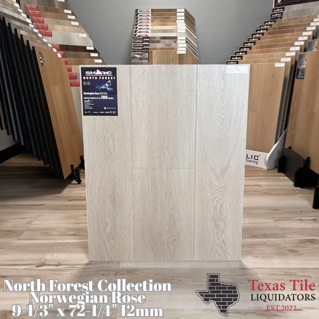 Light wood-look tile display in a showroom with sample boards fanned on both sides.