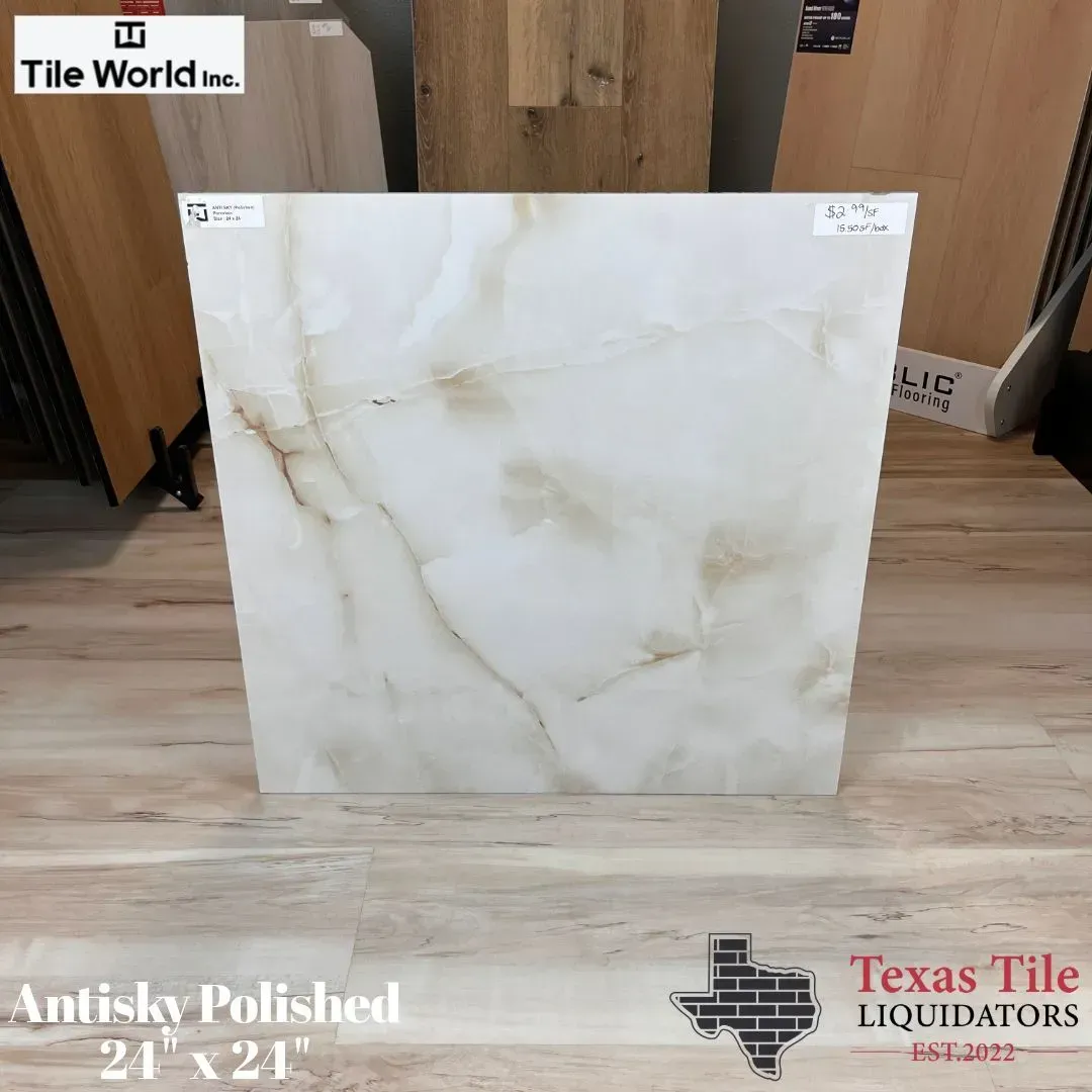 White polished tile slab with subtle beige veining displayed in a tile showroom.