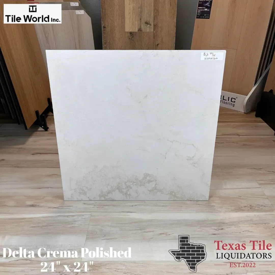 White polished tile slab displayed in a showroom, labeled Delta Crema Polished 2’x2’.