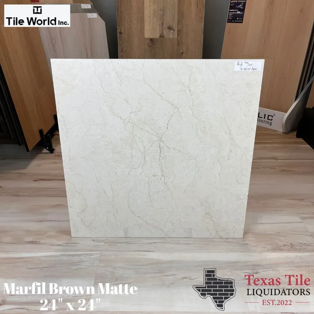 Marfil Brown Matte tile sample, light cream with subtle veining, displayed in showroom