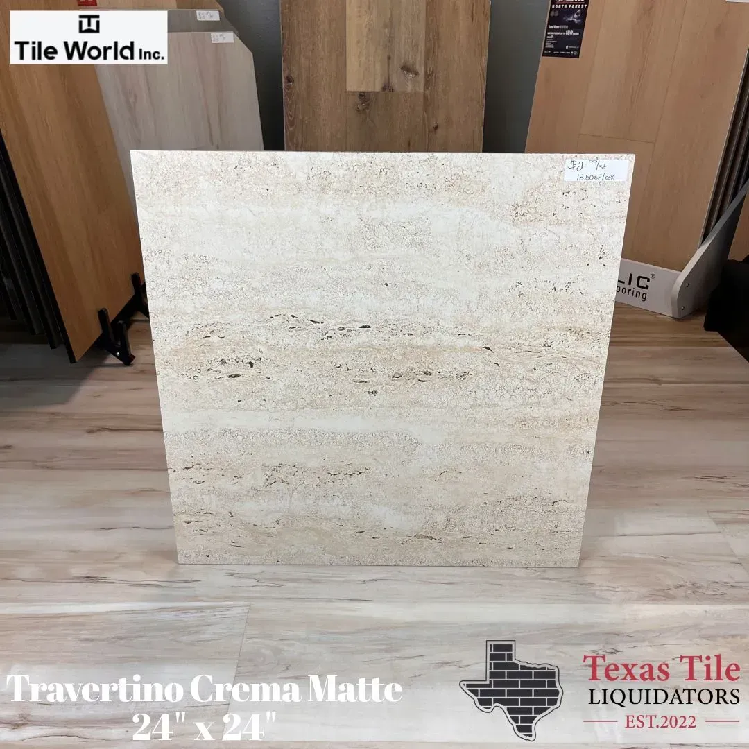 Cream beige travertine tile sample displayed in a showroom, labeled Travertino Crema Matte 24x24.
