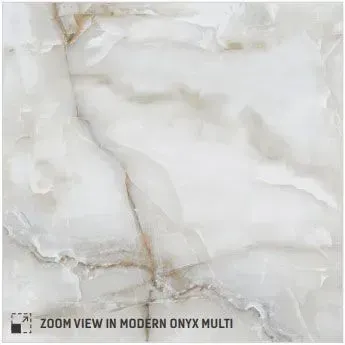 A close-up view of polished, white marble stone featuring soft, flowing grey and gold veining throughout.