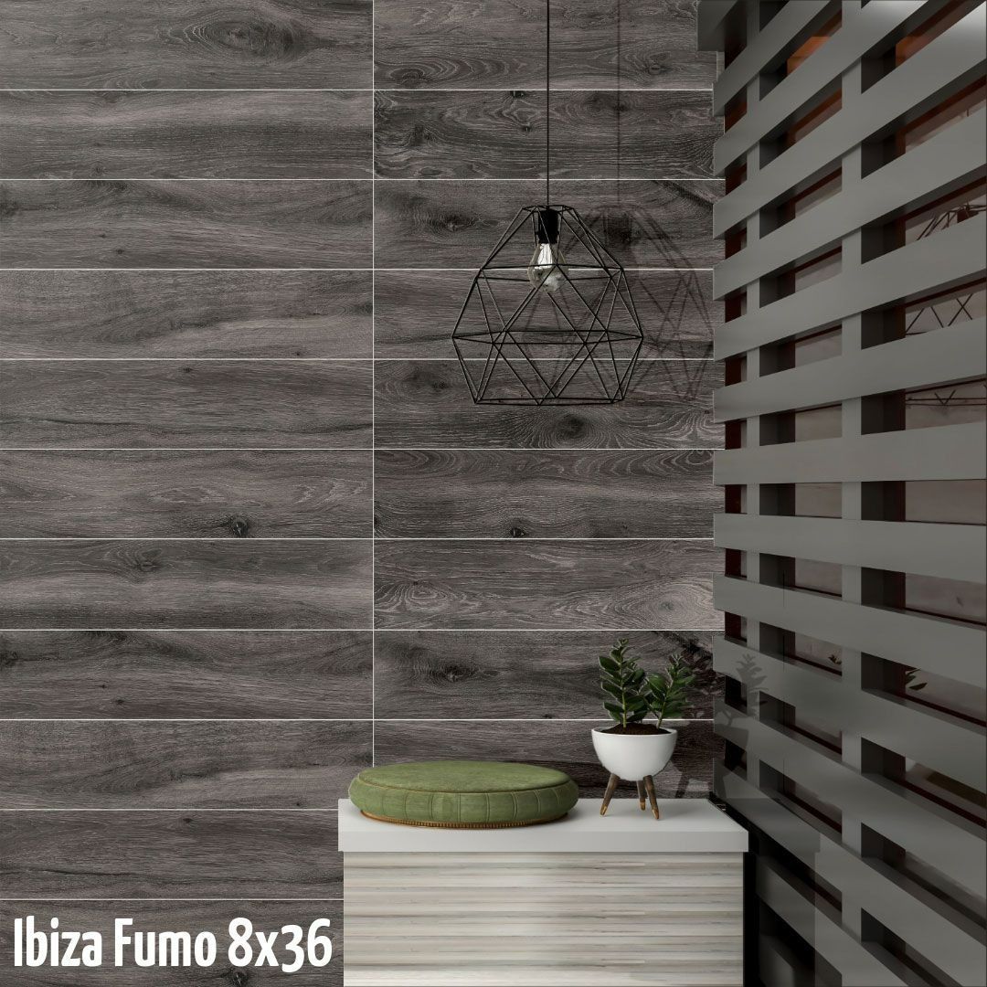 Gray wood-look tiled wall with a geometric wire sconce, slatted screen, and small plant on a bench.