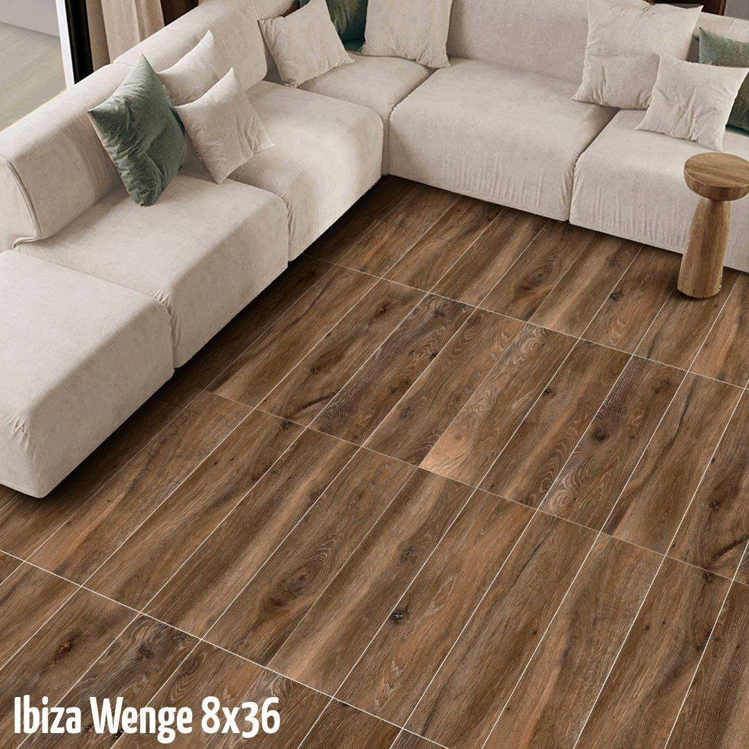 A white modular sectional sofa sits on dark wood-look floor tiles arranged in a grid pattern.