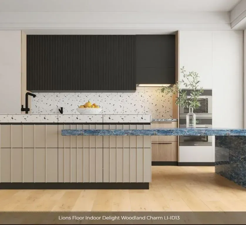 A modern kitchen featuring beige fluted cabinets, terrazzo countertops, black upper cabinets, and light wood flooring.