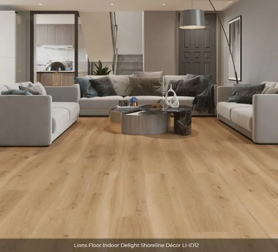 Living room with light wood flooring, a grey sofa set, a coffee table, and a neutral, modern interior design.