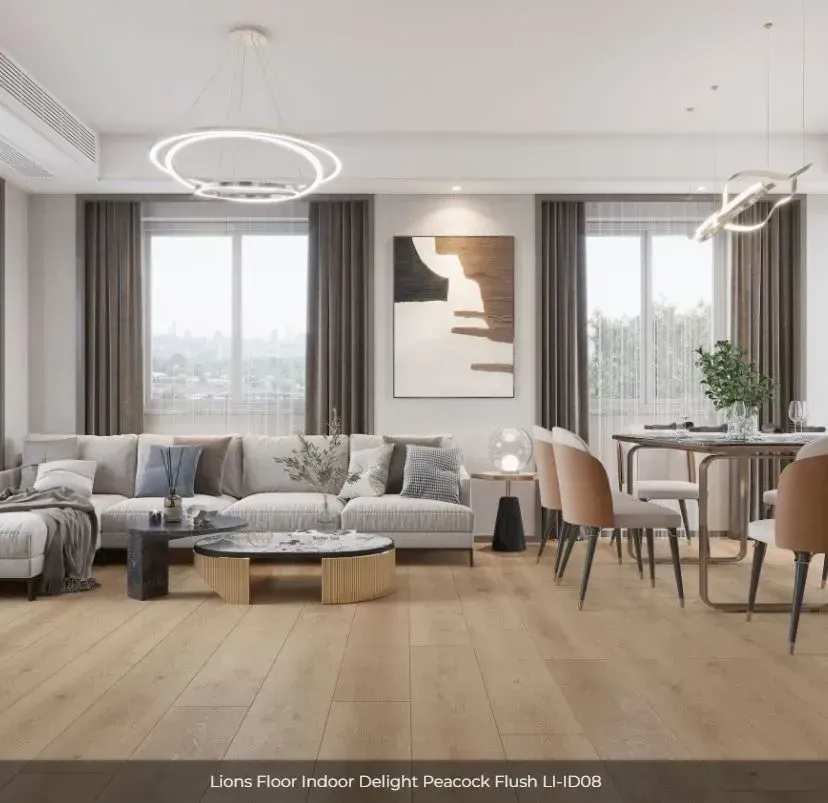 A modern, neutral-toned living and dining area featuring light wood flooring, a grey sofa, and tan dining chairs.