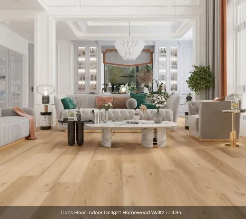 A spacious, modern living room featuring light oak flooring, a tufted gray sofa, and elegant neutral decor.