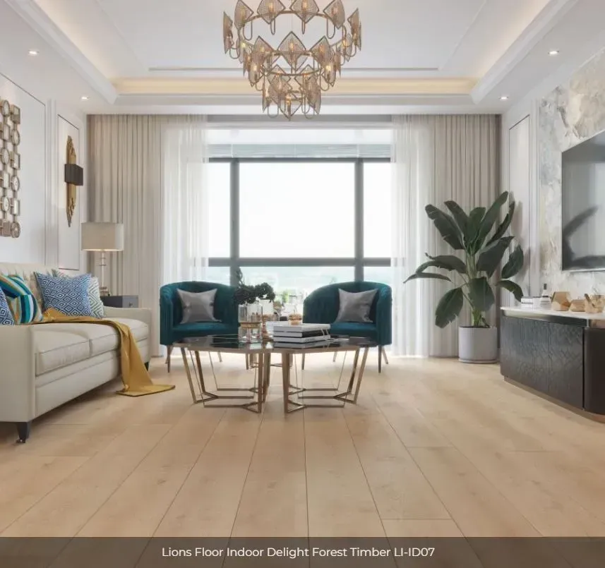 A modern living room with light oak flooring, a cream sofa, two teal armchairs, a central coffee table, and a plant.