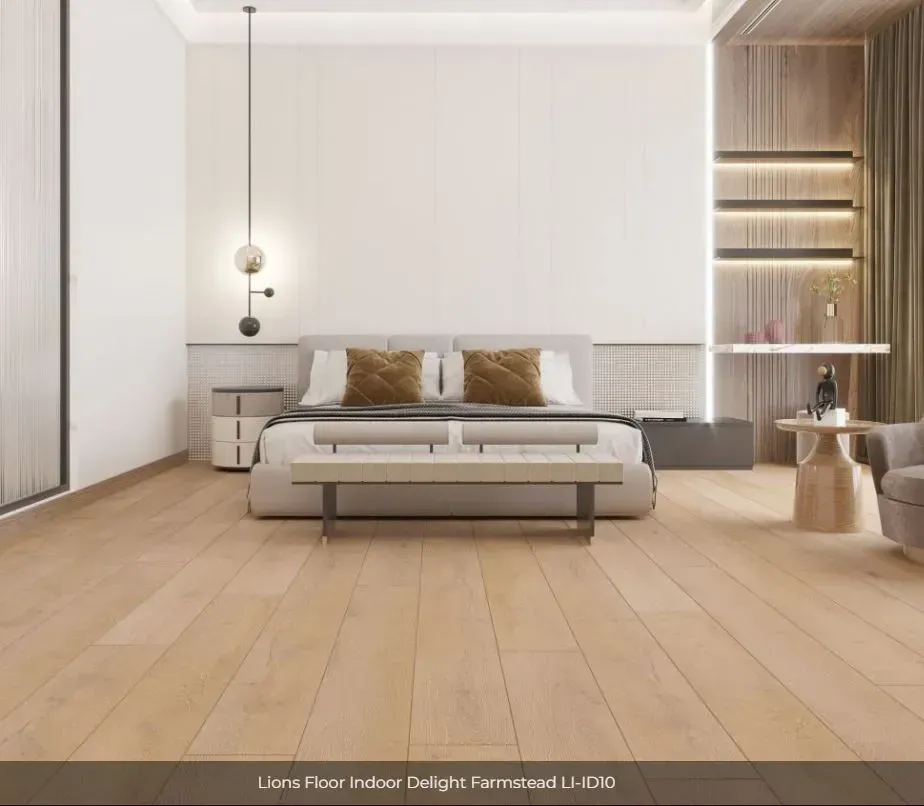 Modern bedroom featuring light oak wood flooring, a neutral bed with brown pillows, and ambient wall lighting.