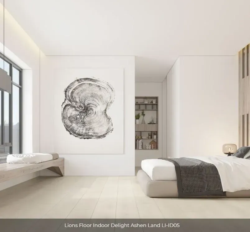A minimalist bedroom with light wood floors, a bed with a gray runner, a large tree ring wall art, and a built-in shelf.
