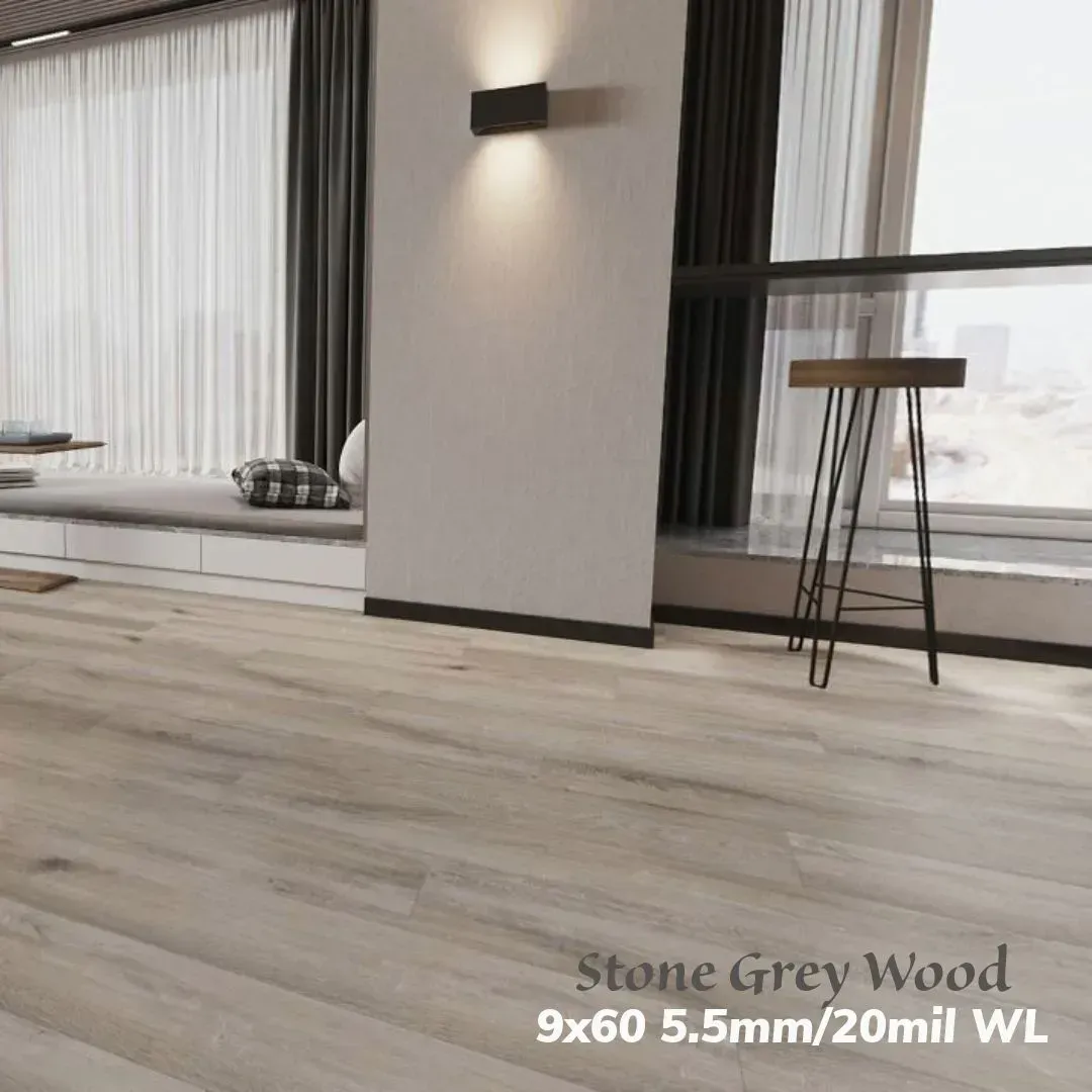 A modern room with light grey wood-look flooring, featuring a window seat and a stool against floor-to-ceiling curtains.