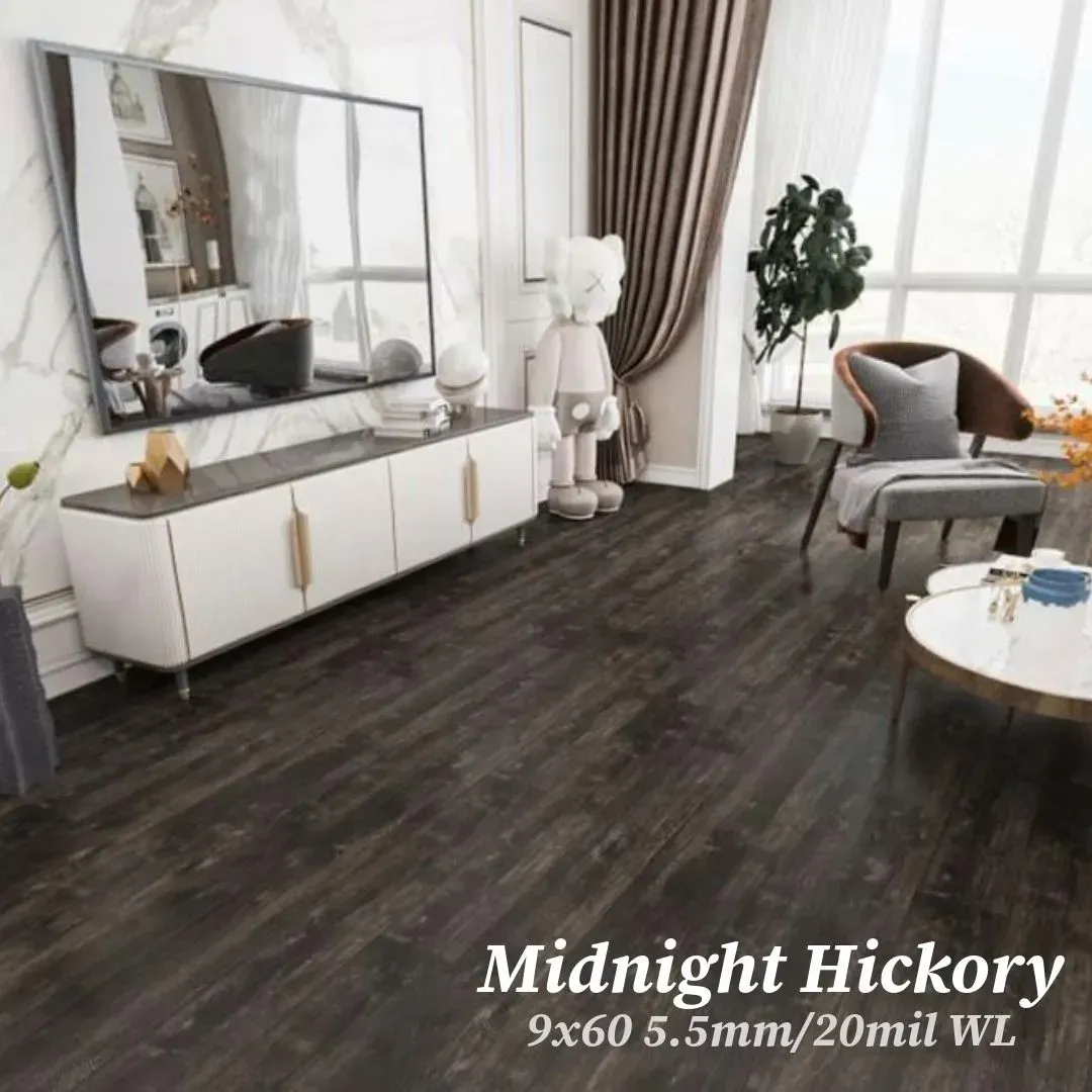 A modern living room with dark wood flooring, a white sideboard, a large mirror, an armchair, and a decorative figure.