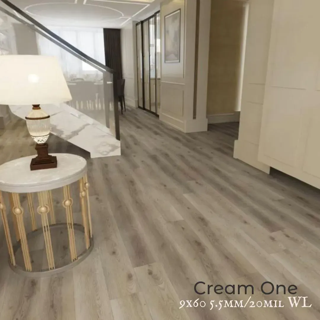 Modern hallway with cream walls, wood-look flooring, staircase, and round side table with lamp.