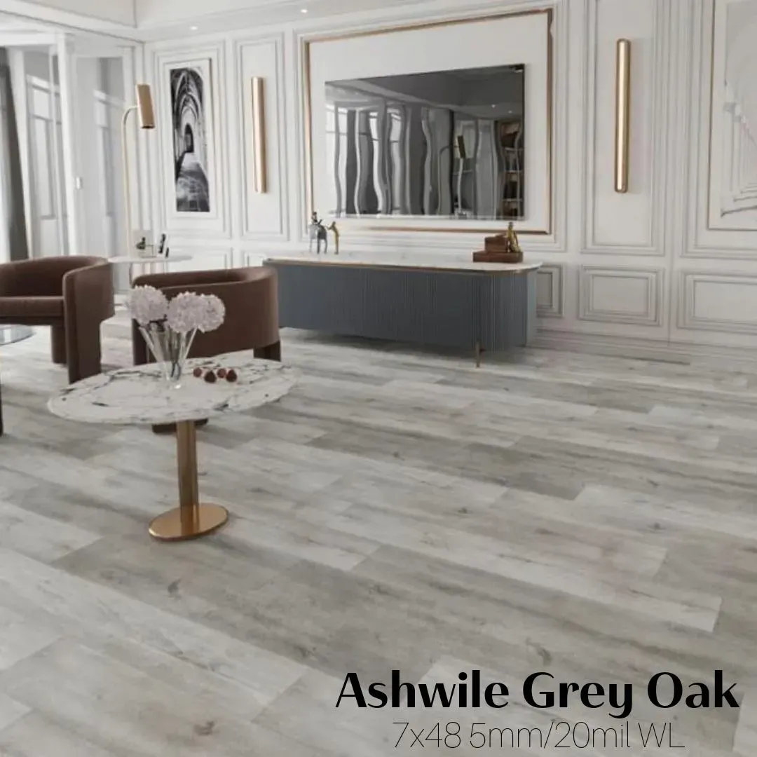 A bright living room featuring Ashwile Grey Oak flooring, a marble-top table, and modern dark blue cabinetry.