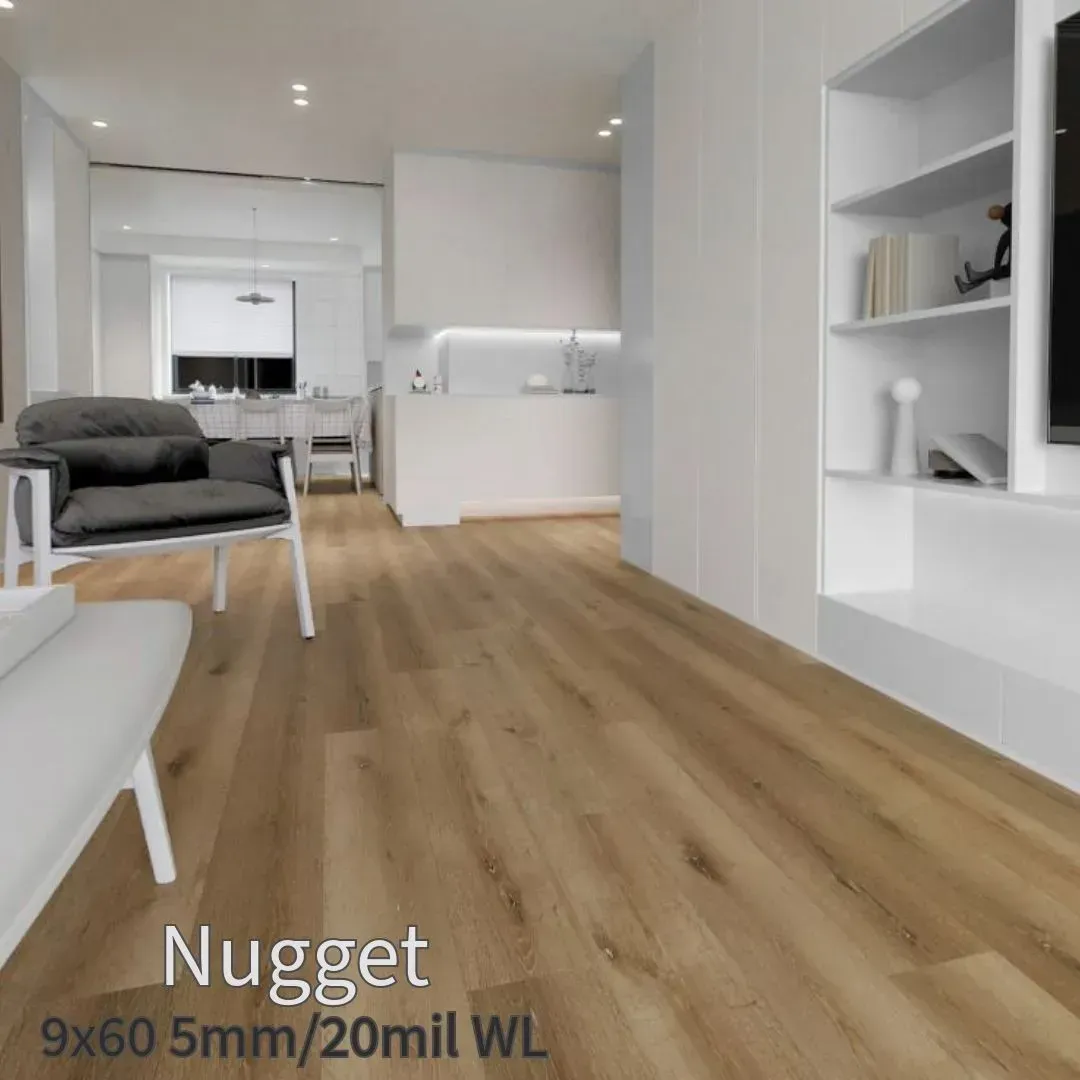 A bright, modern living room with light brown wood flooring, a grey accent chair, and built-in white shelving.