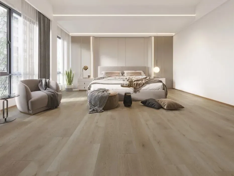 A modern, minimalist bedroom with light wood flooring, a bed, a curved armchair, and floor-to-ceiling windows.