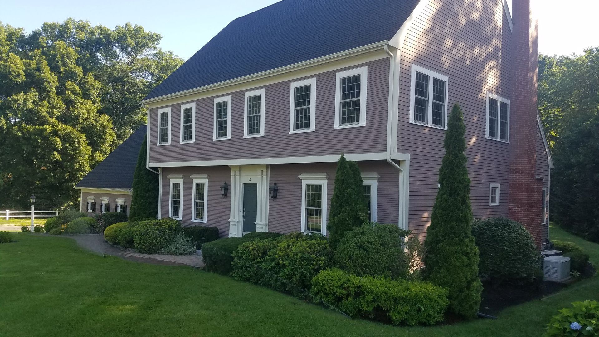 A large house with a lot of windows and a black roof.