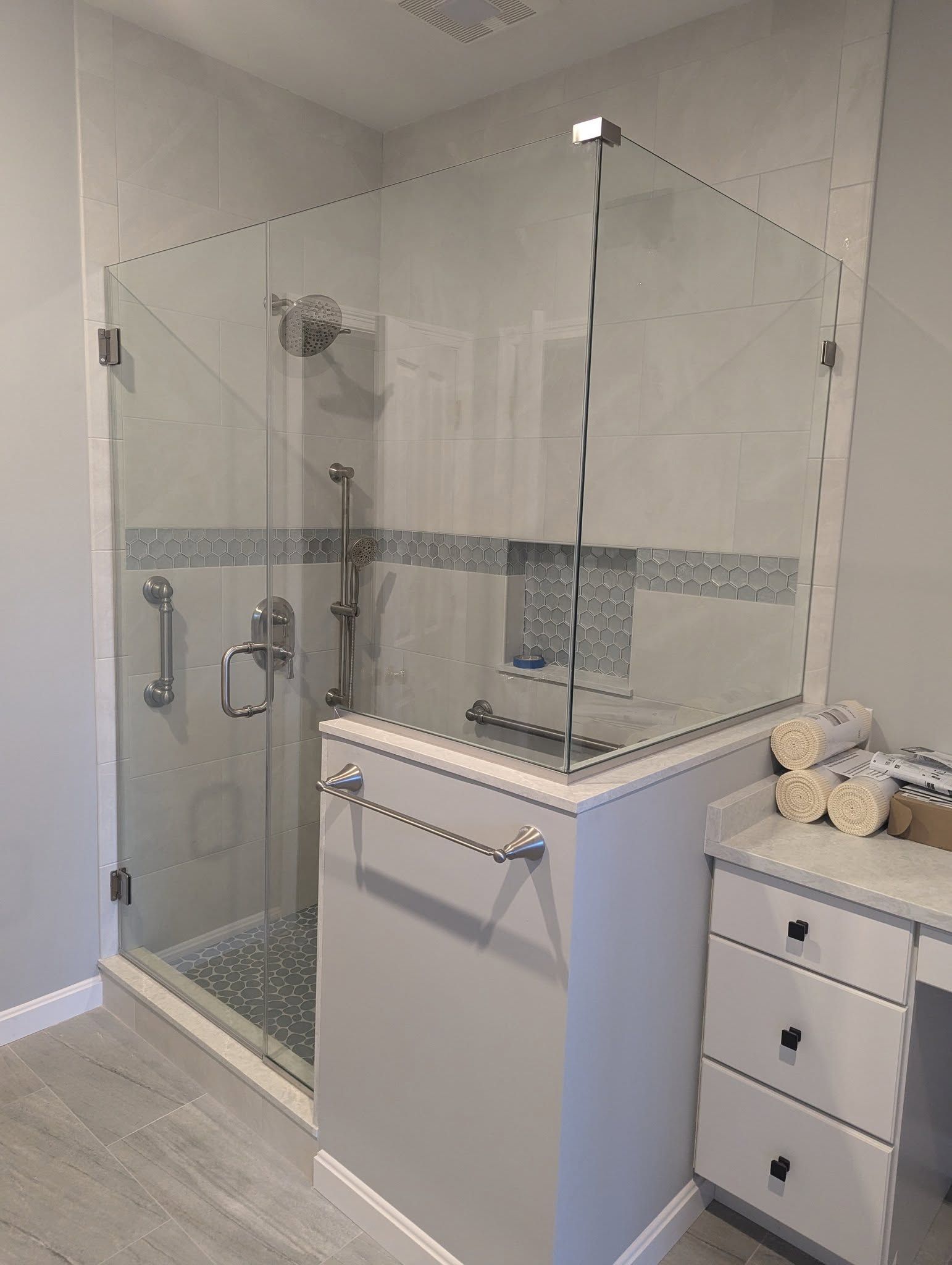 A bathroom with a walk-in shower and a sink.