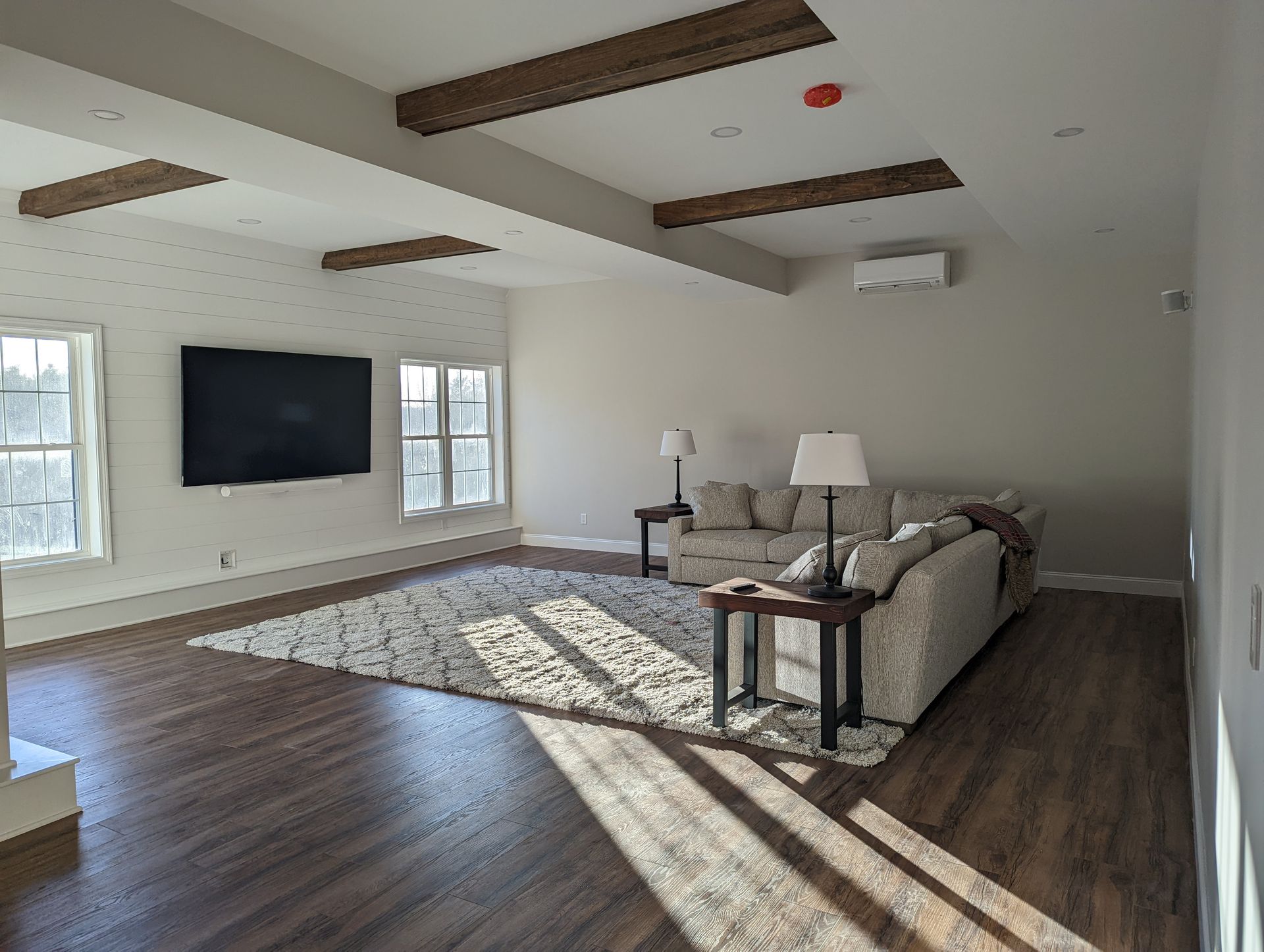 A living room with a couch and a flat screen tv
