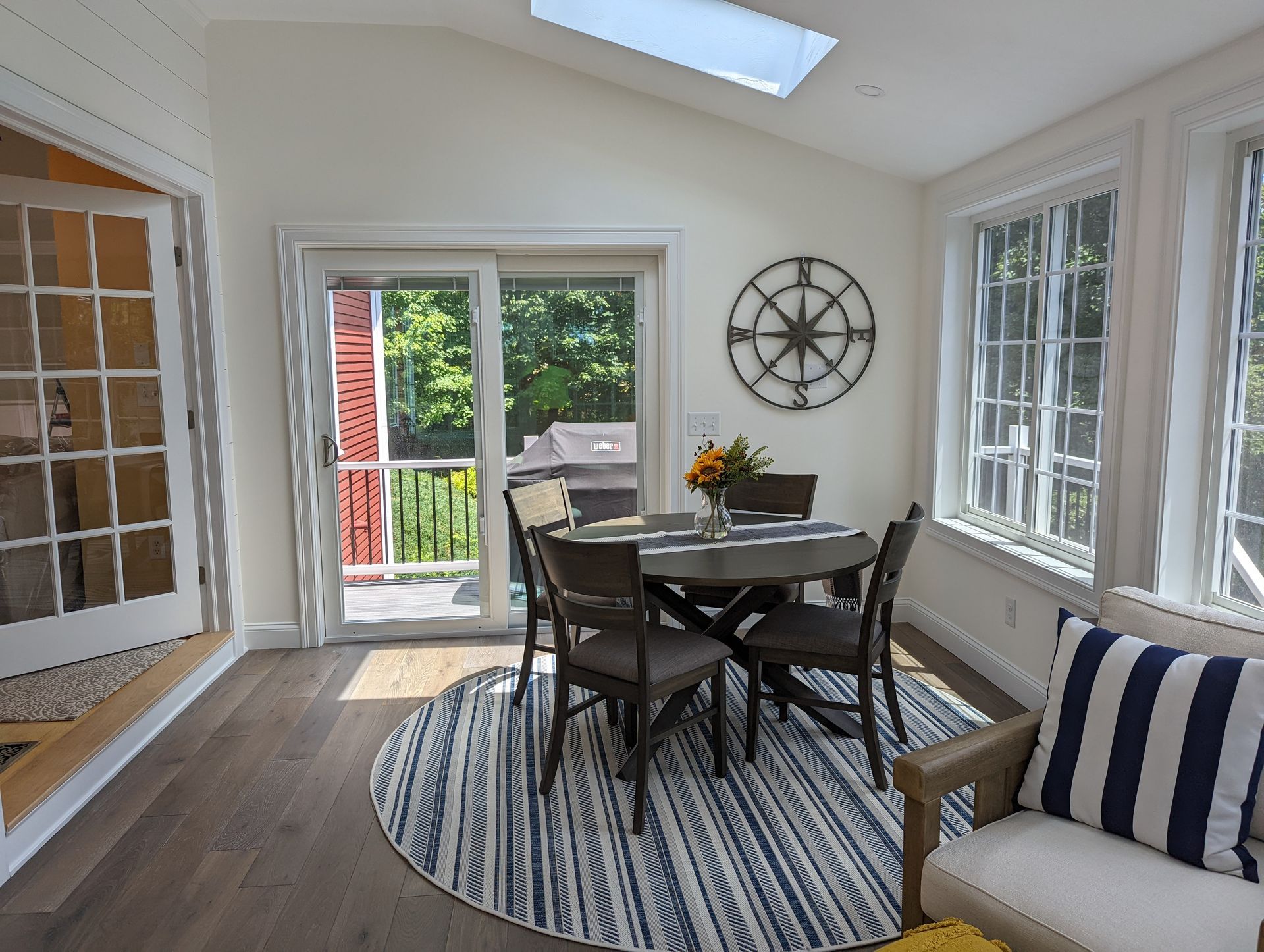 A dining room with a table and chairs and a rug