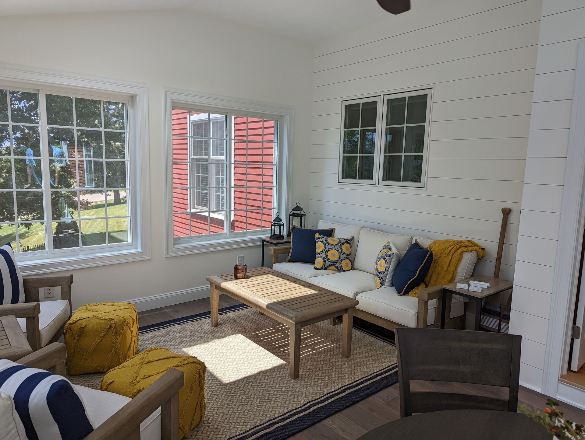 A living room with a couch, chairs, and a table.