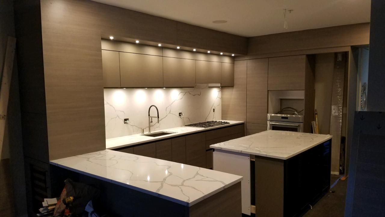 A kitchen with a large island in the middle of it.