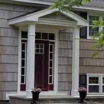 A house with a porch and a red door.
