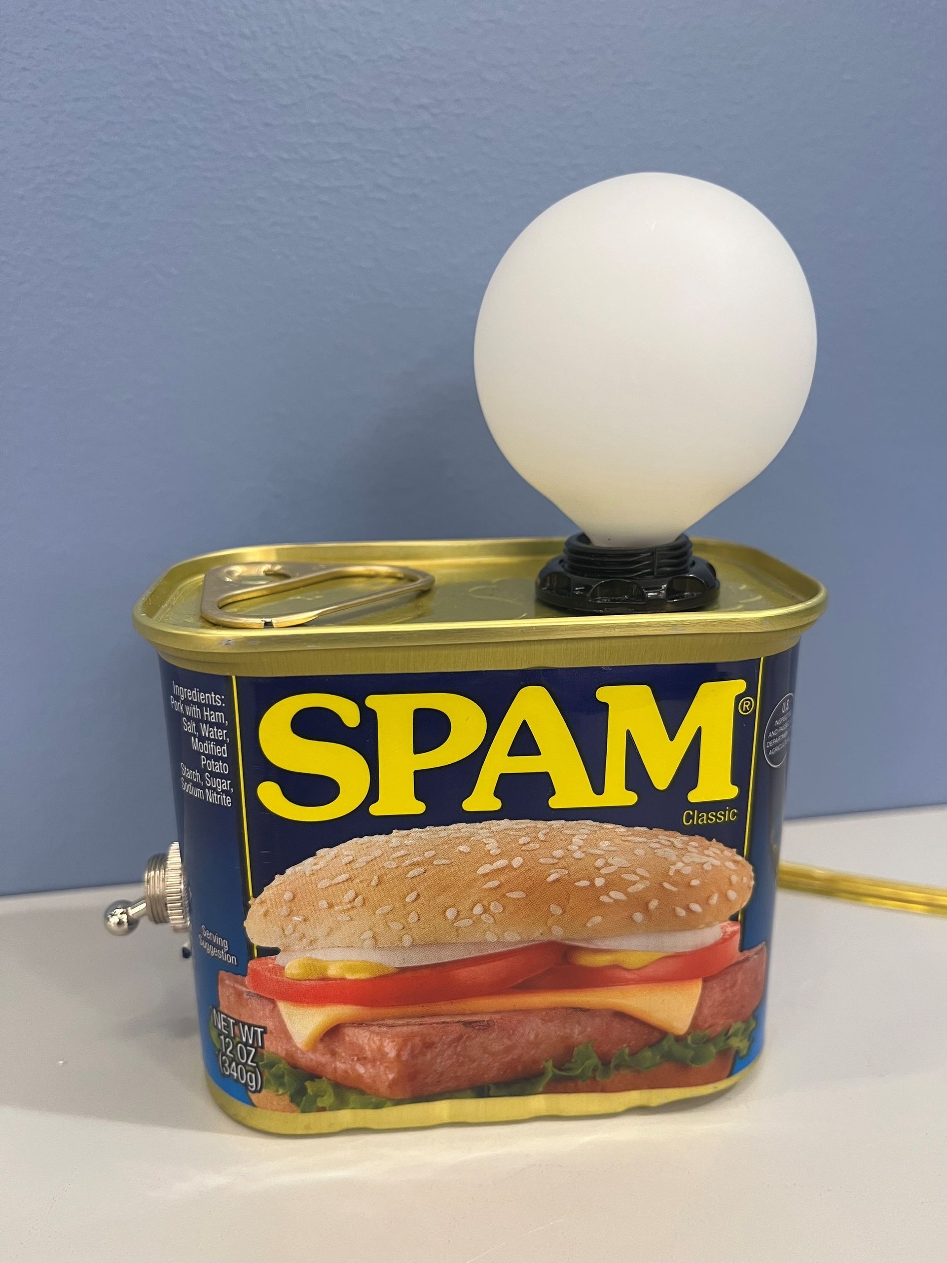 A Spam can with a small, glowing white ball attached on top.