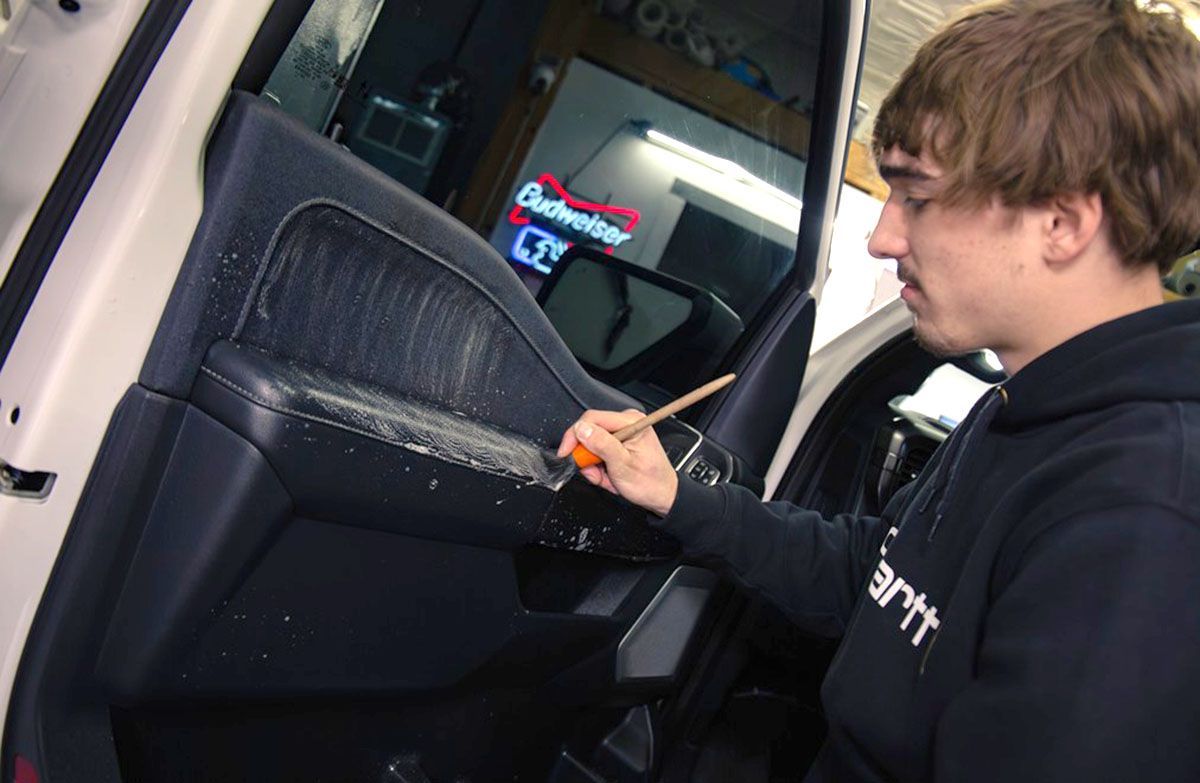 a man cleaning a car's interior