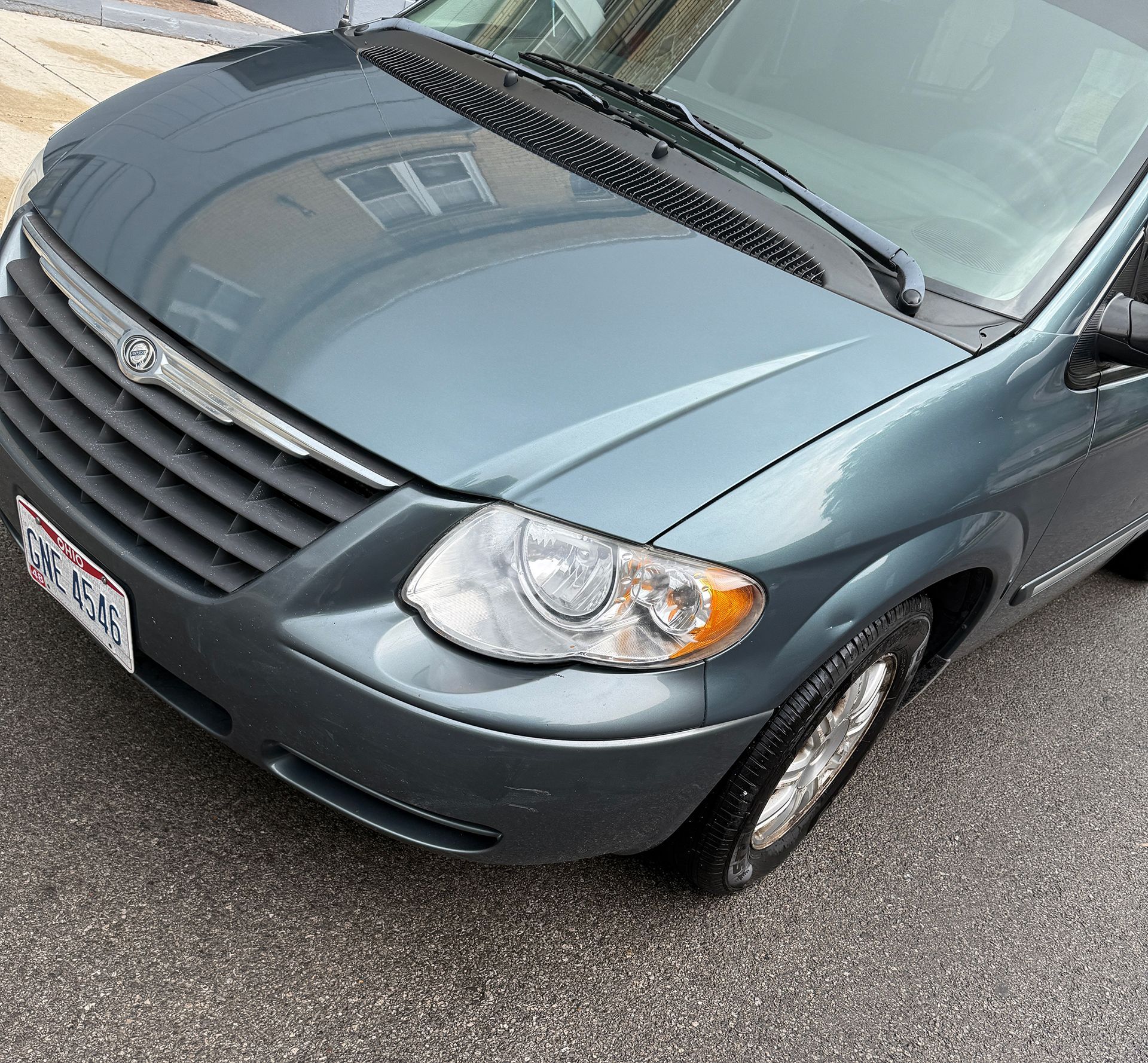 Blue minivan parked on asphalt.