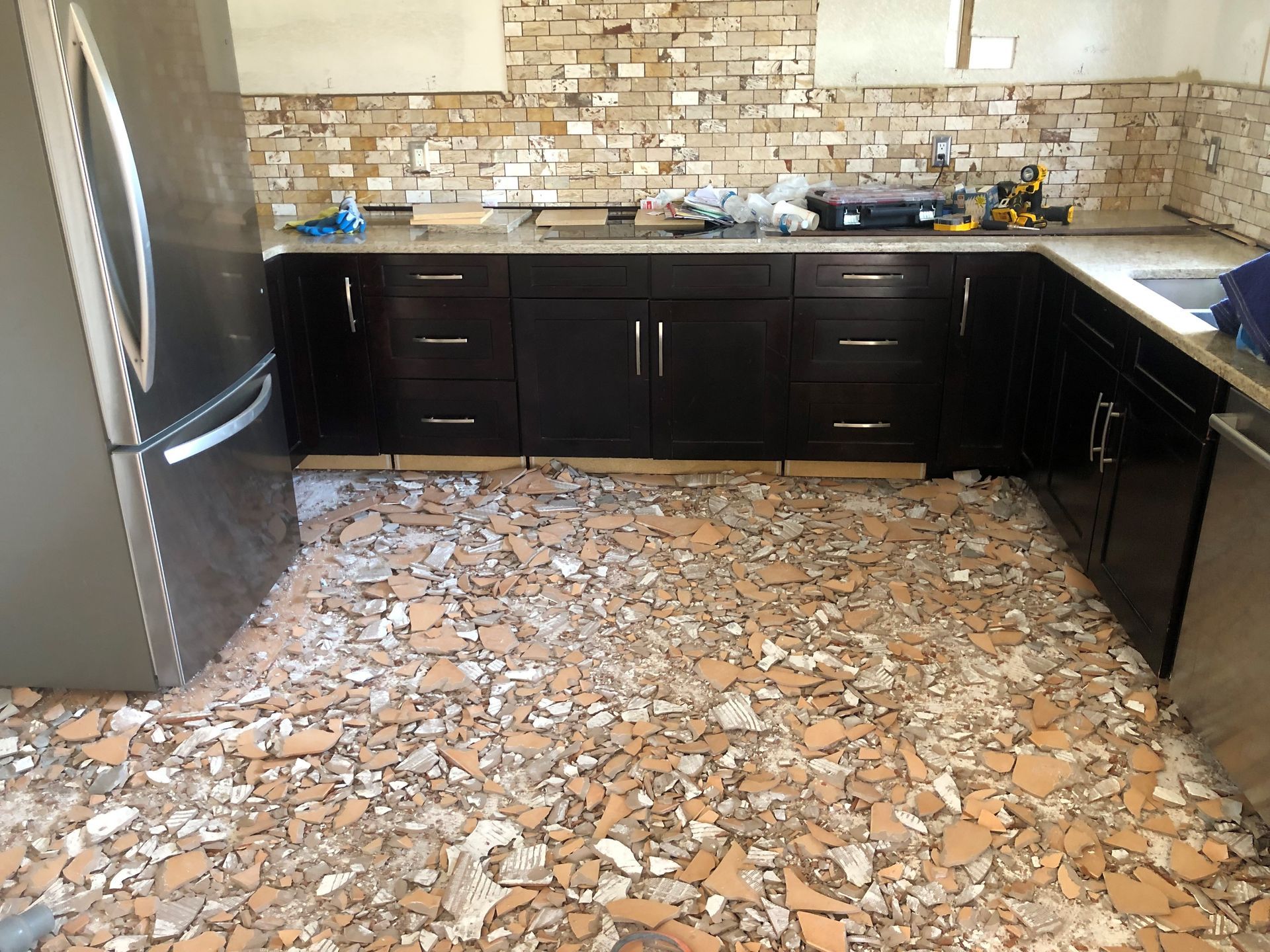 A kitchen with a lot of bricks on the floor