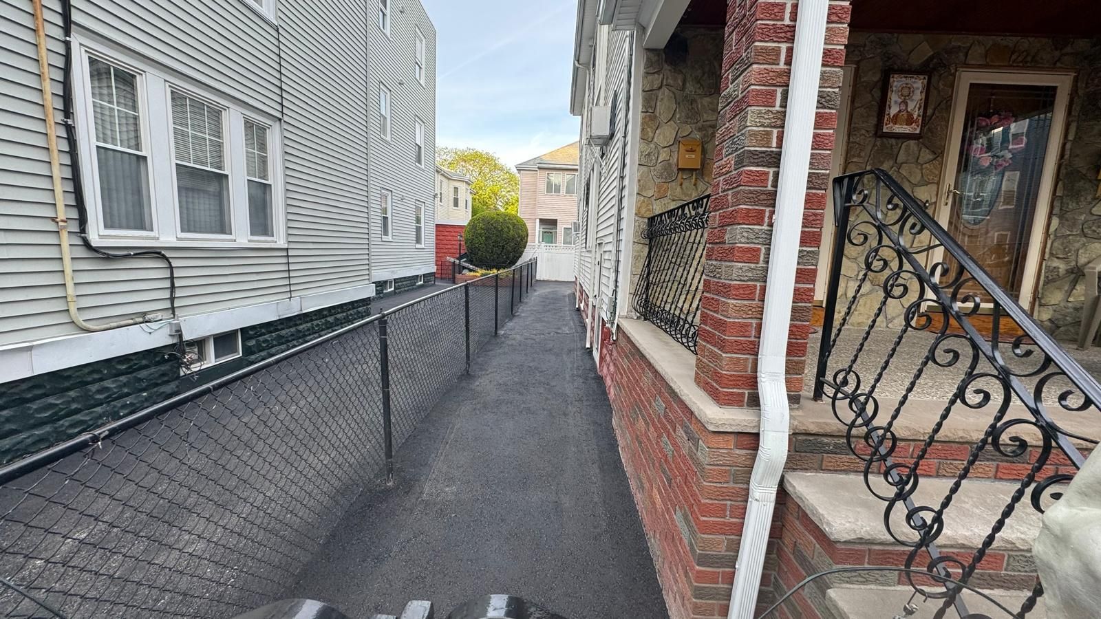 Sidewalk next to brick house 