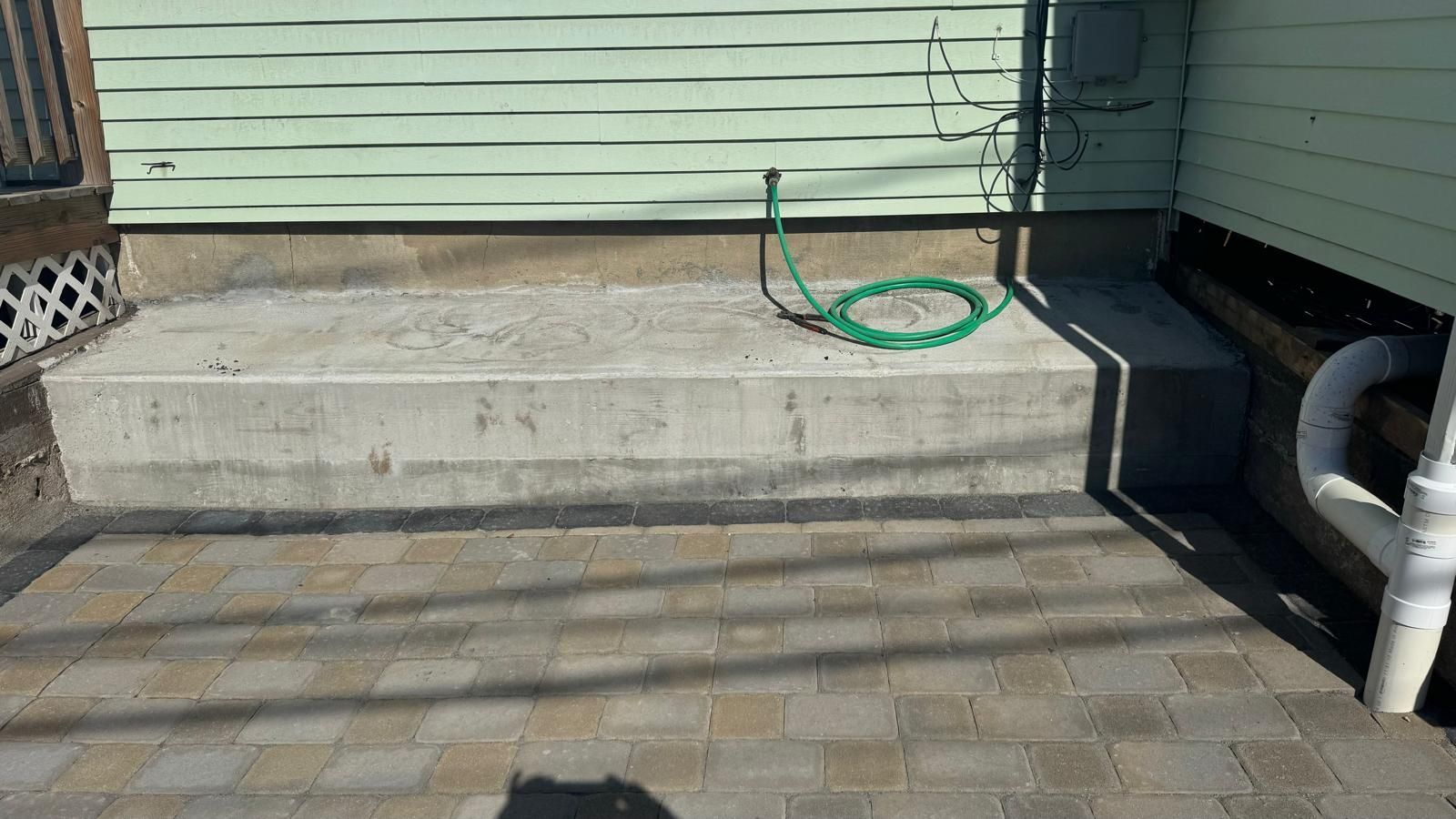 Concrete stair with green hose