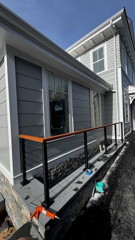 A house with a wooden railing on the side of it.