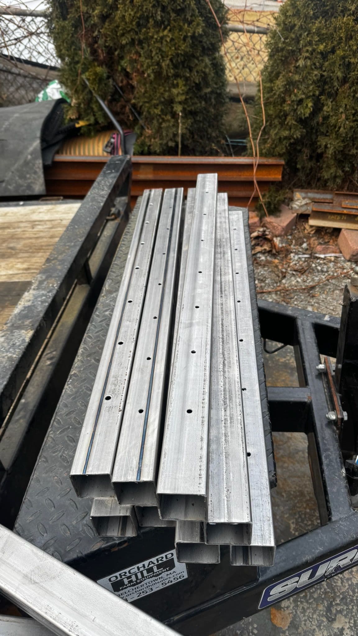 A stack of metal pipes sitting on top of a trailer.