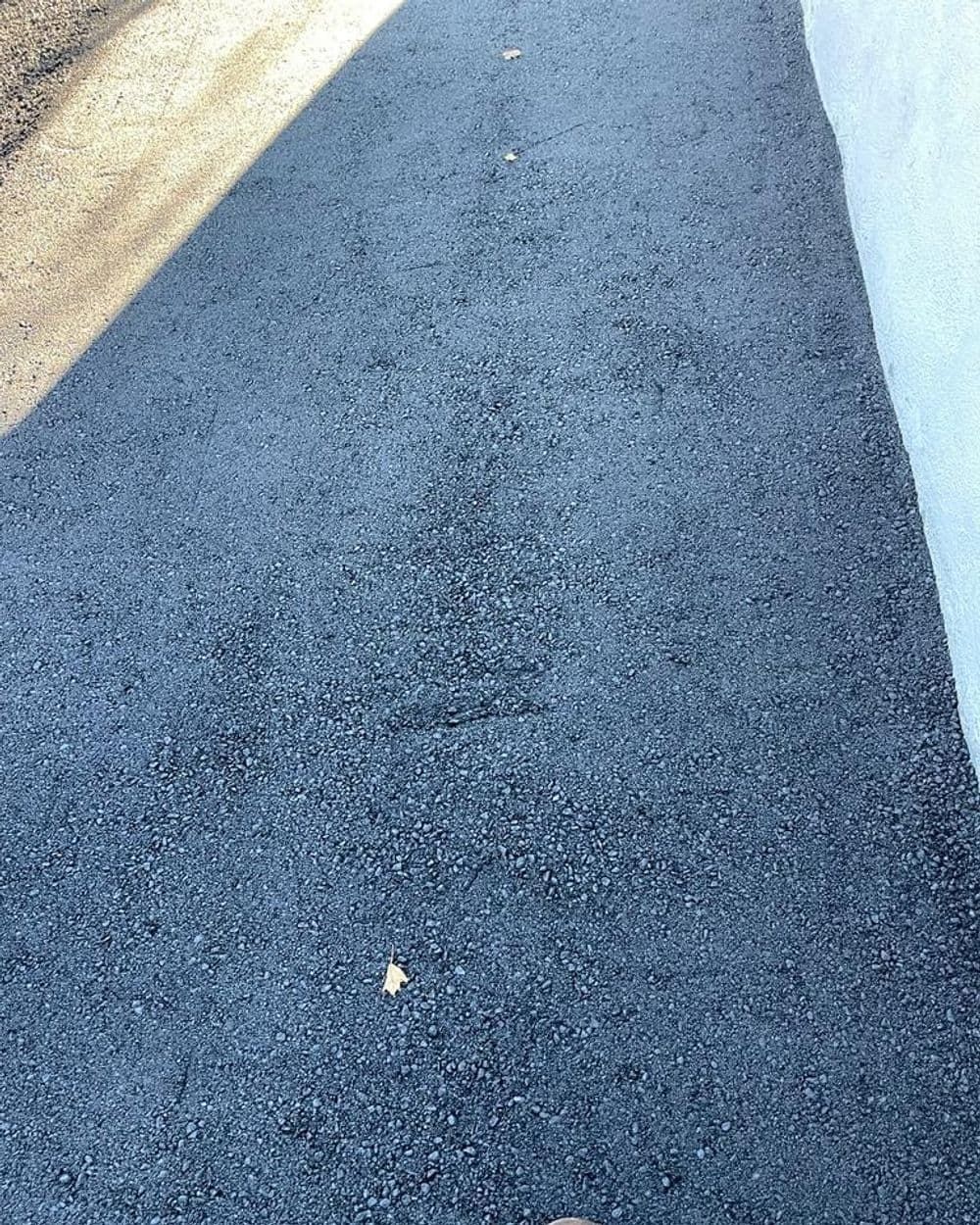 A close up of a black asphalt road.