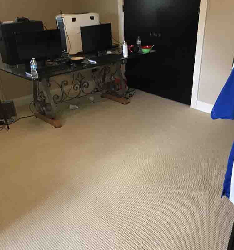 A carpeted floor with a desk in the background - after