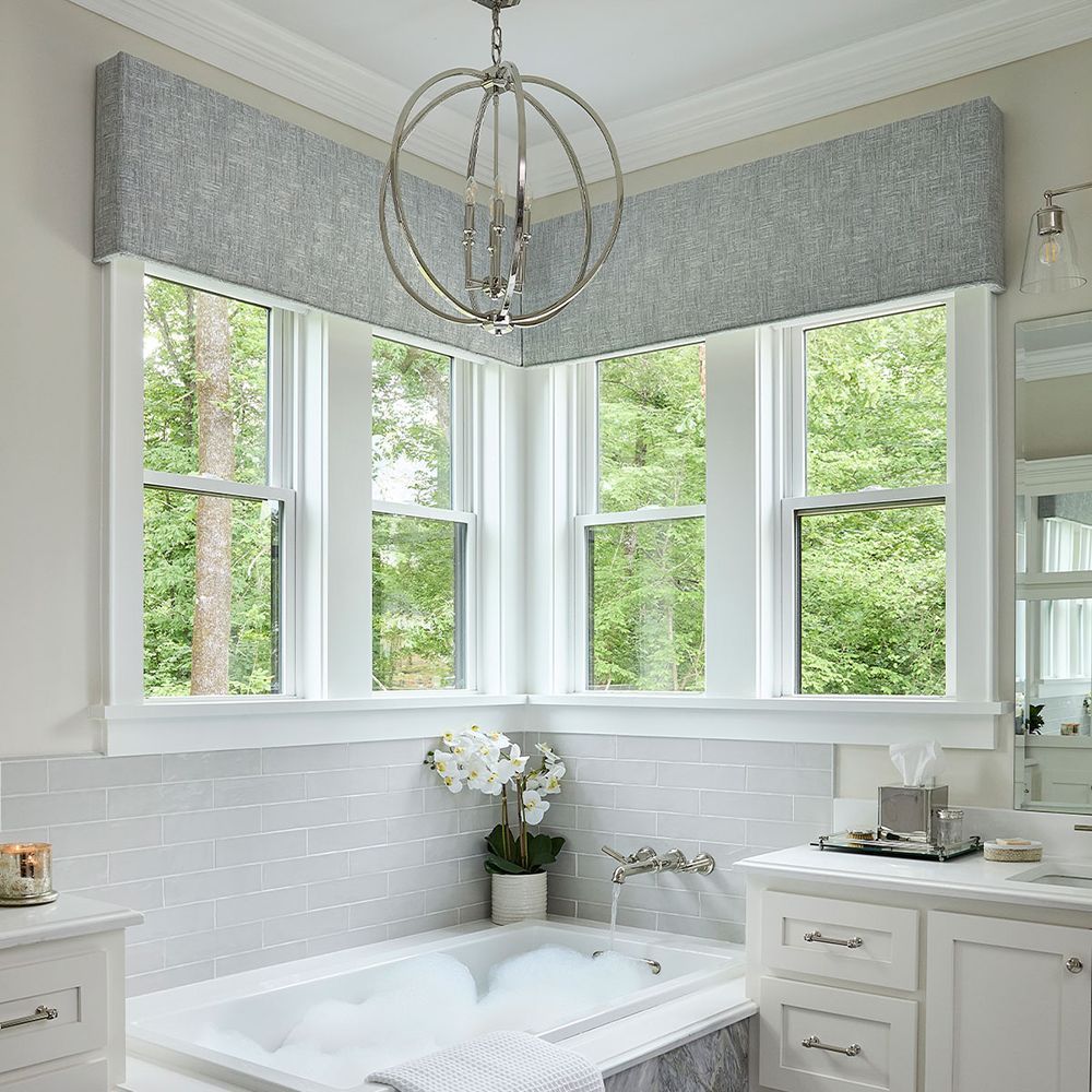 A bathroom with a bathtub and a large window