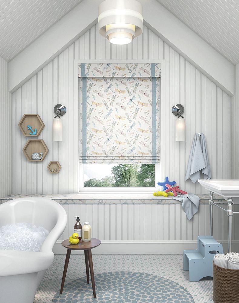 A bathroom with a bathtub and a window with roman shades