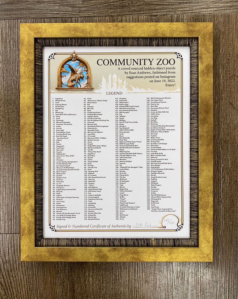 A picture of a community zoo is framed on a wooden table