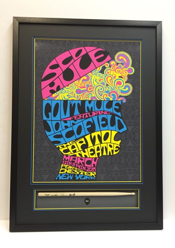 A framed poster with a pen in it