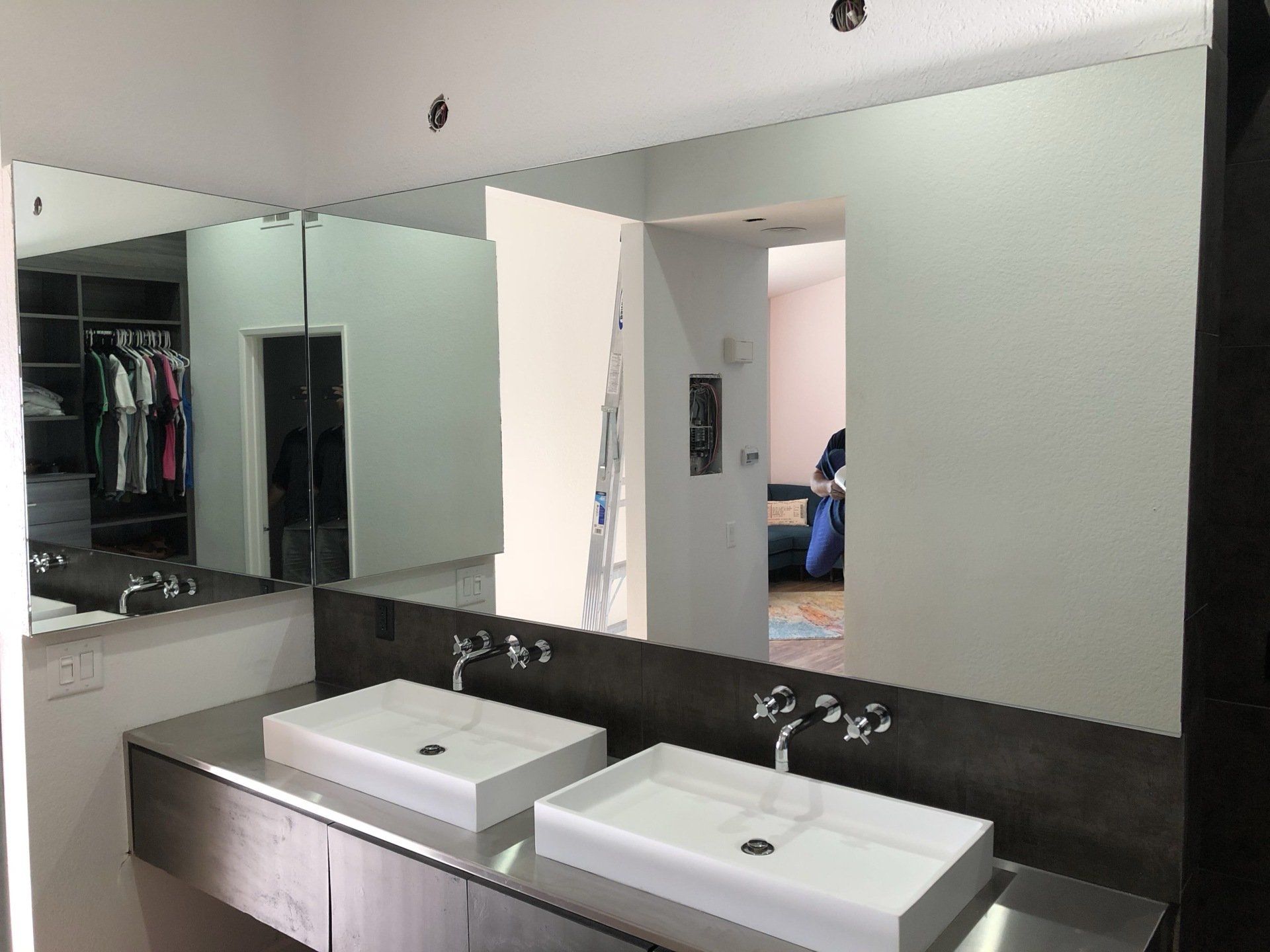 A bathroom with two sinks and a large mirror